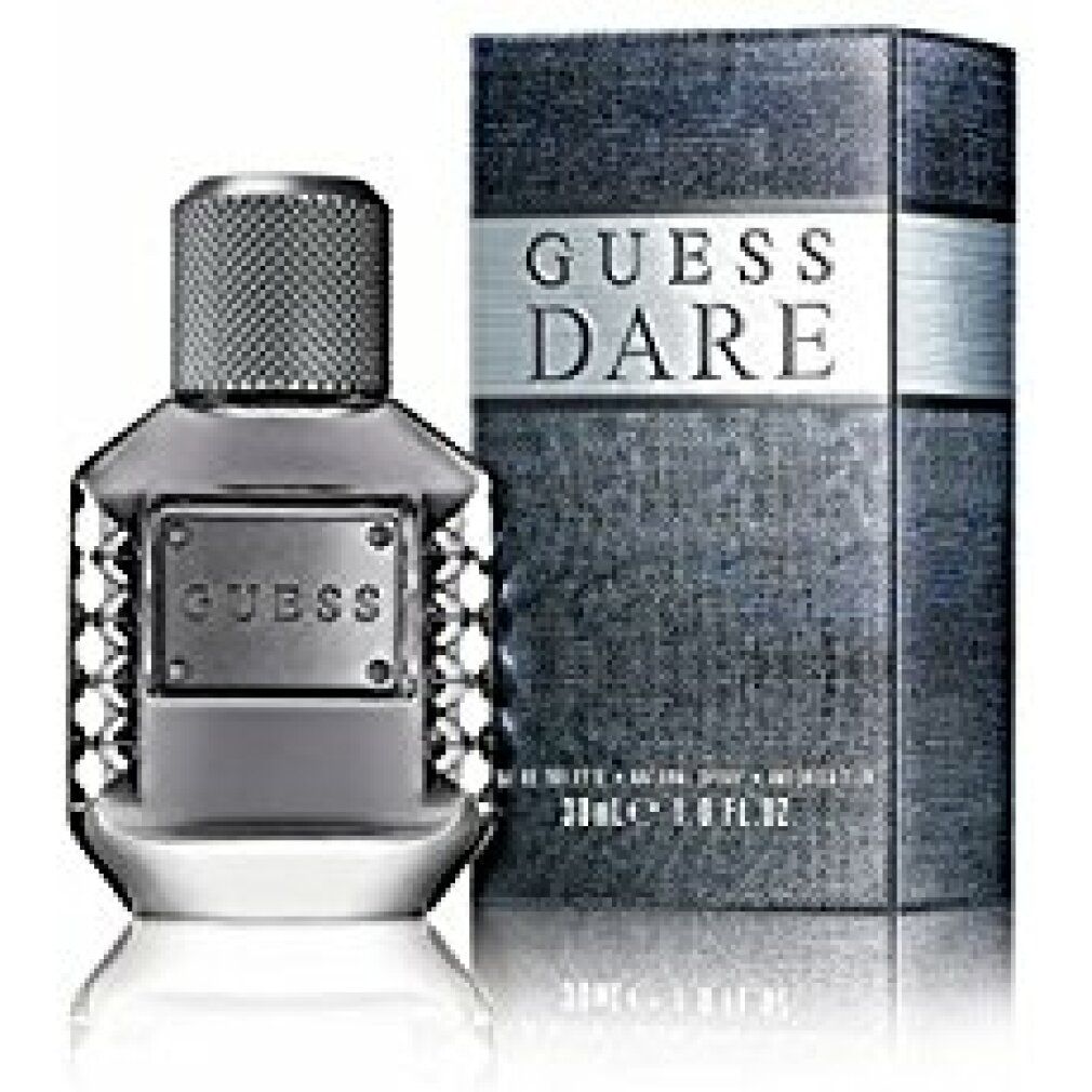 Flakon und Verpackung. Auf der Verpackung steht "GUESS DARE". Der Flakon hat einen silbernen Verschluss und die Aufschrift "GUESS".
