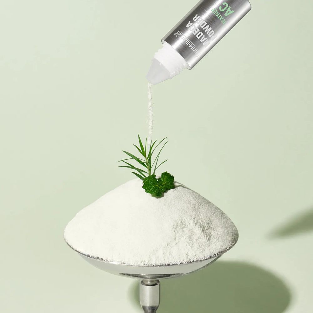 Produkt gießt Puder auf eine Waage. Aufschrift: MADECA POWDER, TeaTree AC. Auf der Waage: Puder und Pflanze.