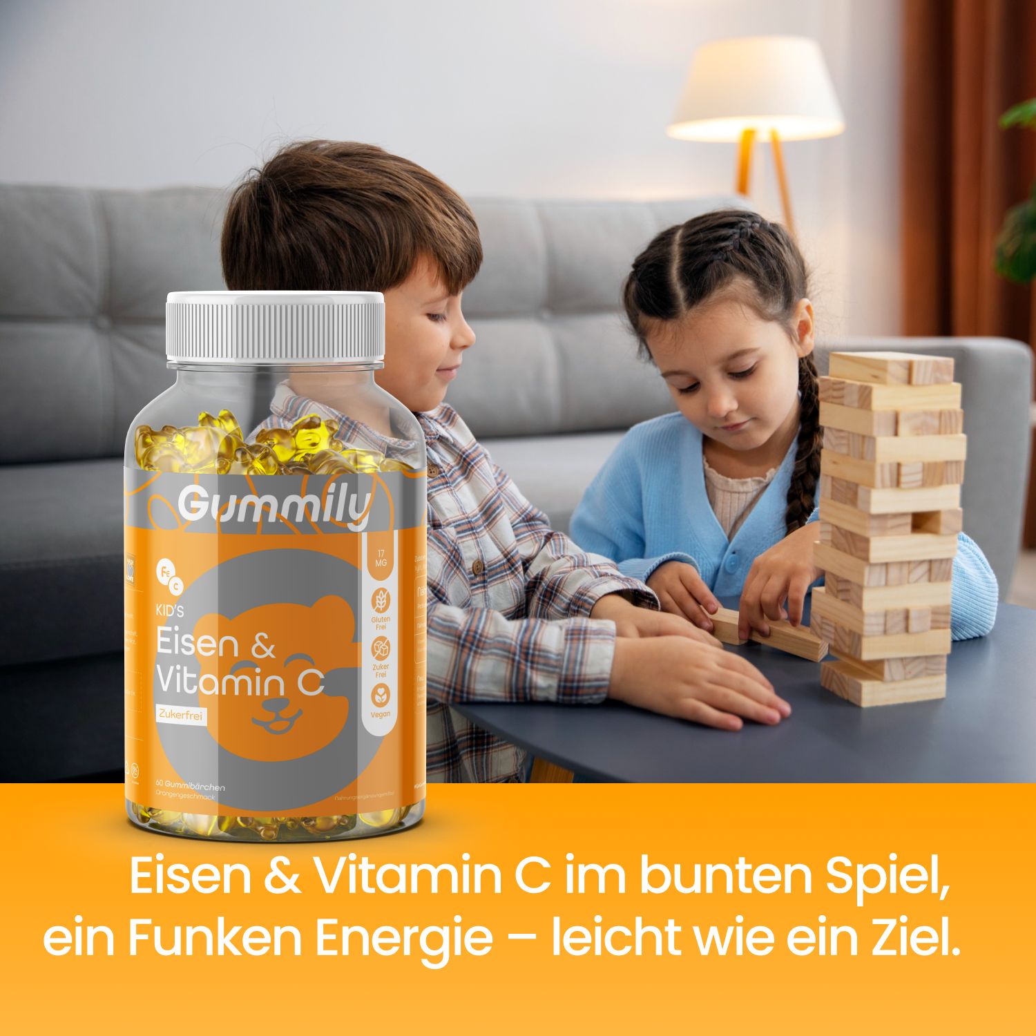 Flasche Gummily Eisen & Vitamin C neben Kindern, die Turm bauen.