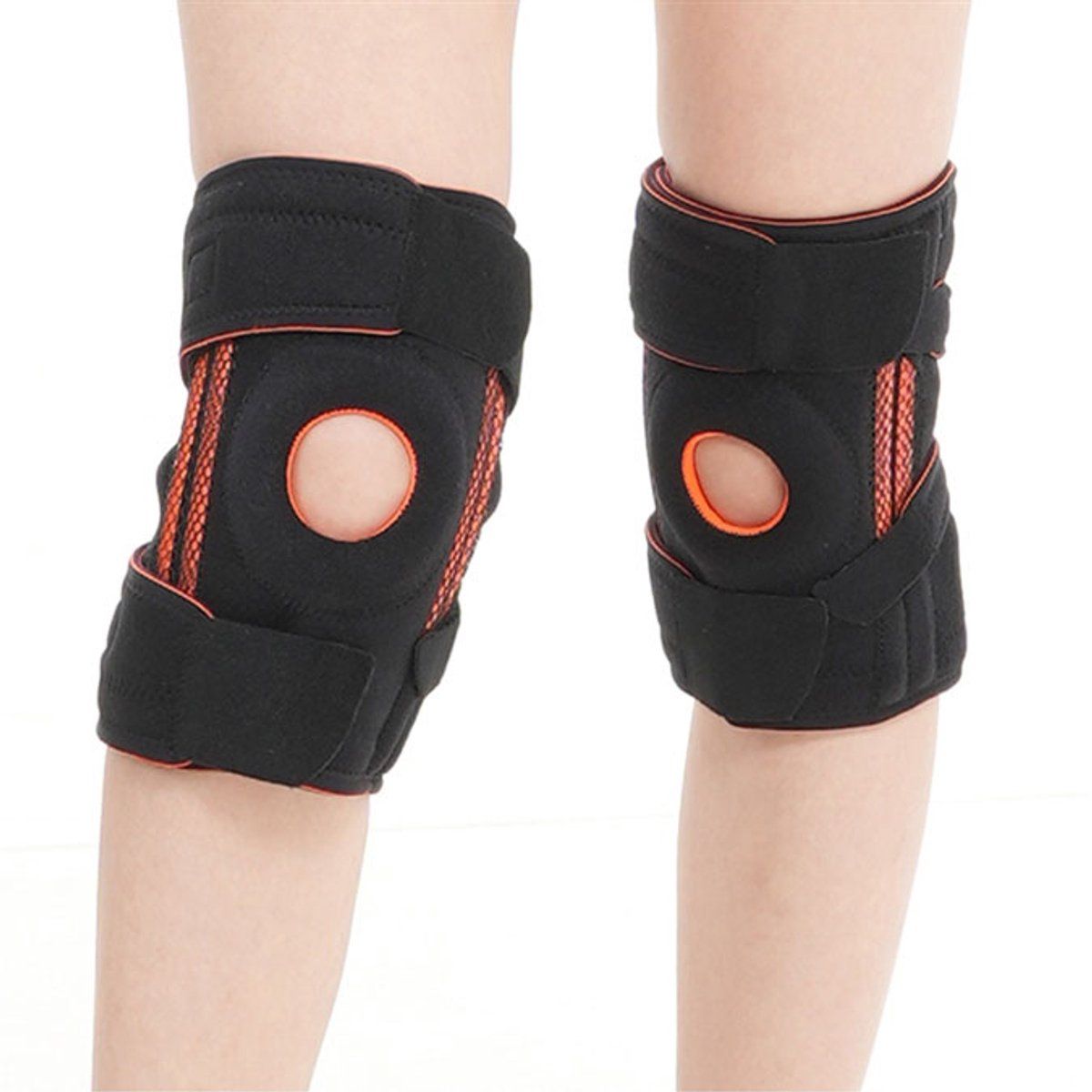 Zwei Kniebandagen, schwarz mit orangefarbenen Details. Öffnung für die Kniescheibe.