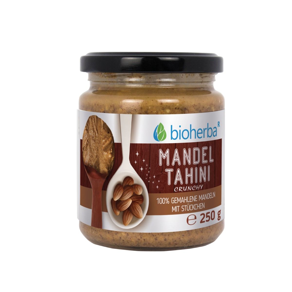 Glas Mandel Tahini Crunchy mit schwarzem Deckel. Etikett mit Produktinformationen und Bioherba Logo. 250 g.