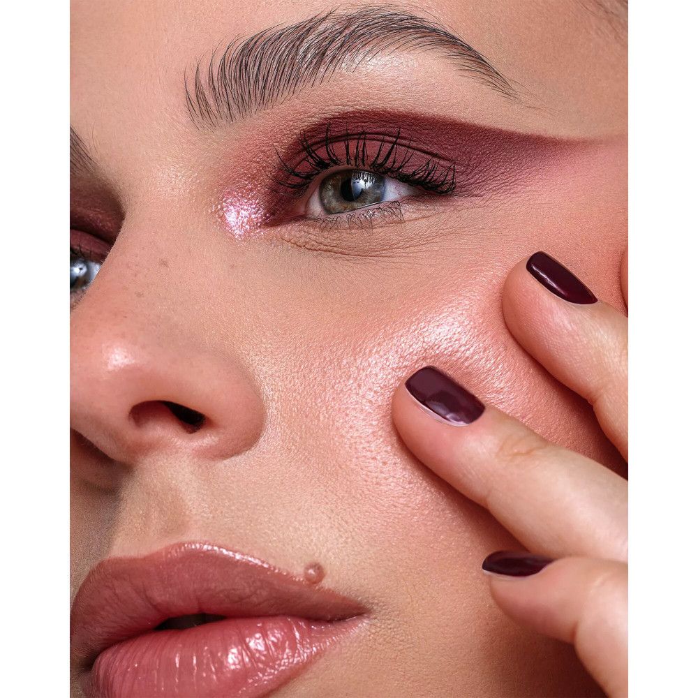 Nahaufnahme eines Gesichts. Lippen mit Lippenstift. Augen mit Lidschatten und Eyeliner.