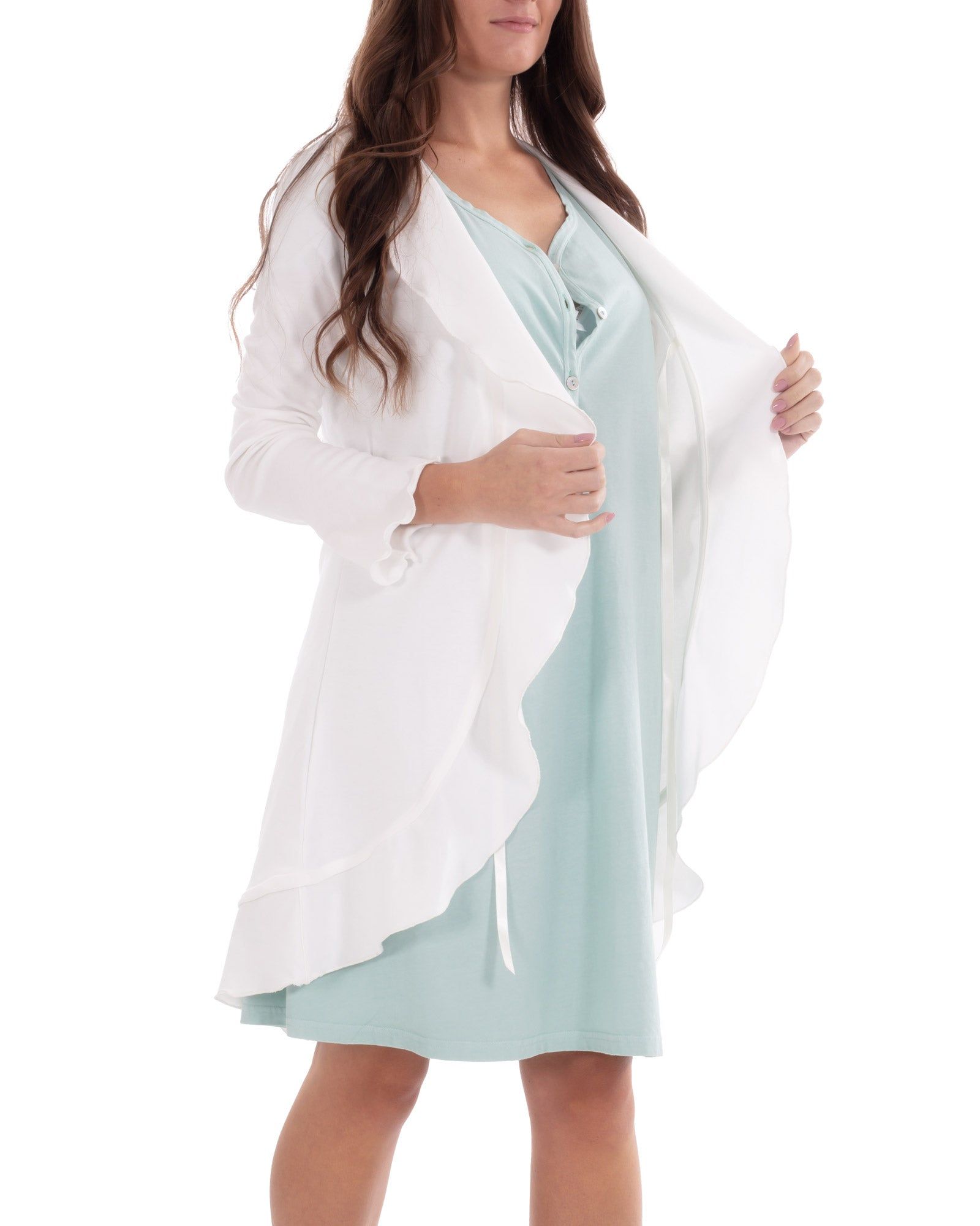 Weißer Morgenmantel mit Volant-Details, über einem hellblauen Kleid. Frau trägt den Mantel offen.