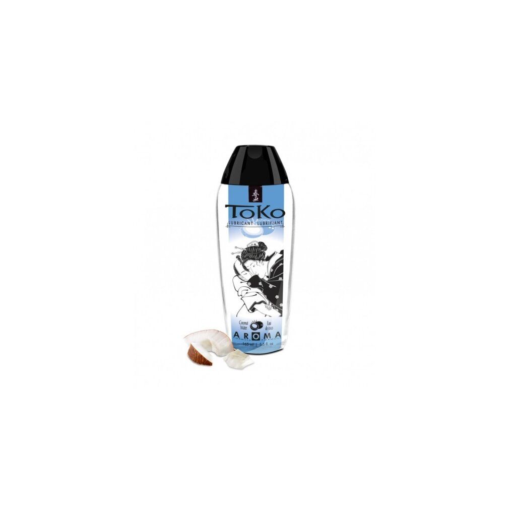ToKo Aroma Kokoswasser Gleitmittel in transparenter Flasche mit schwarzem Verschluss. Kokosnussstücke daneben.