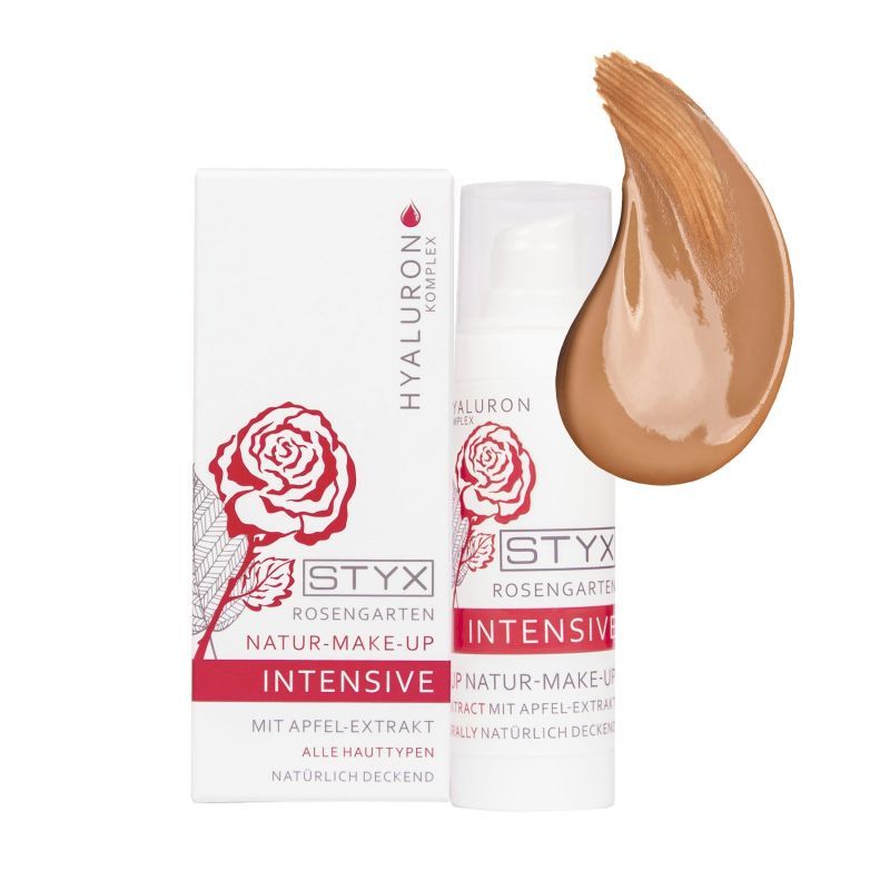 Weiße Verpackung und Flasche mit STYX Rosengarten INTENSIVE Natur-Make-Up. Aufgetragenes Make-up daneben. Text: Hyaluron Komplex, Apfelextrakt.