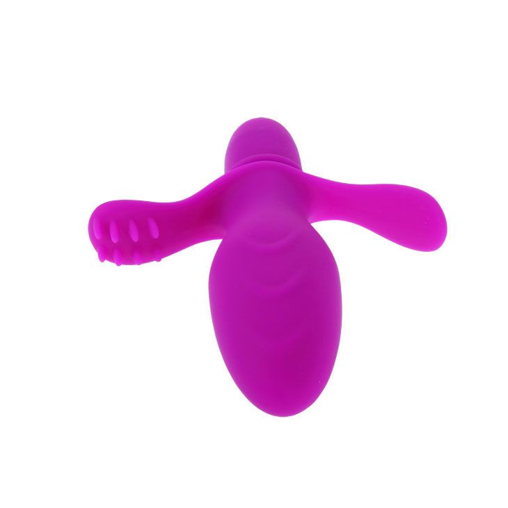 Lila Vibrator mit Flügeln und Noppen. Aus Silikon. Oben abgerundet, unten zylindrisch.