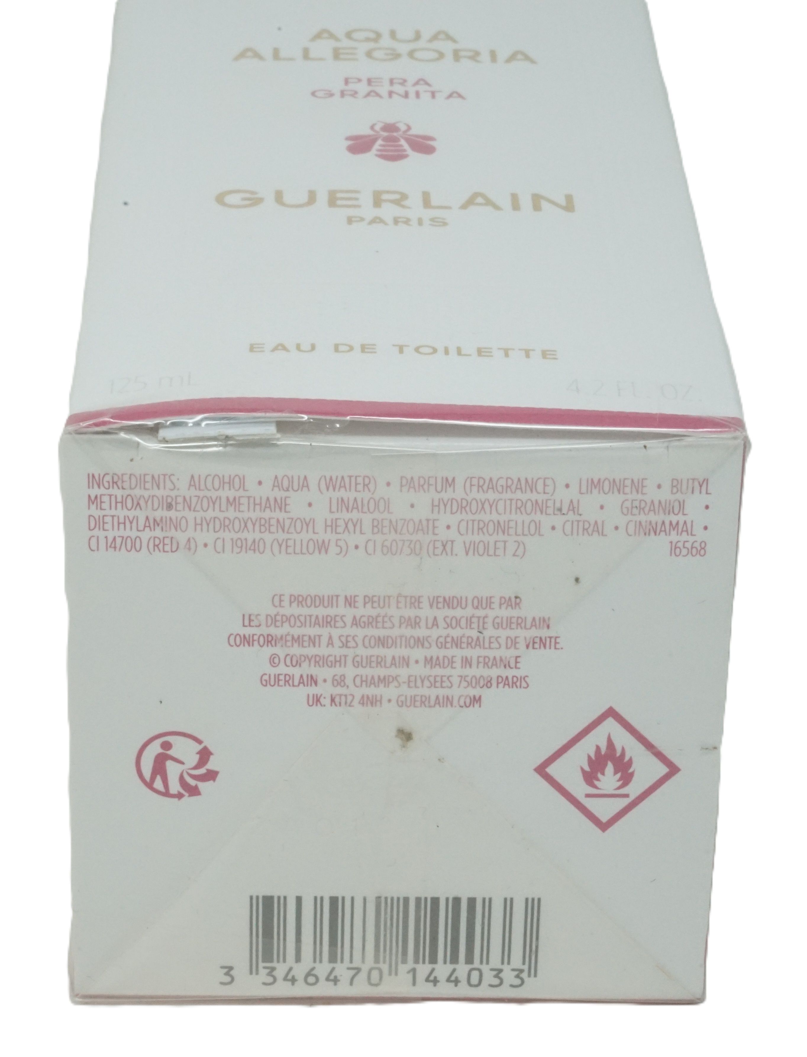Weiße Verpackung mit Produktnamen und Inhaltsstoffen. Roter Warnhinweis und Barcode. Marke Guerlain.
