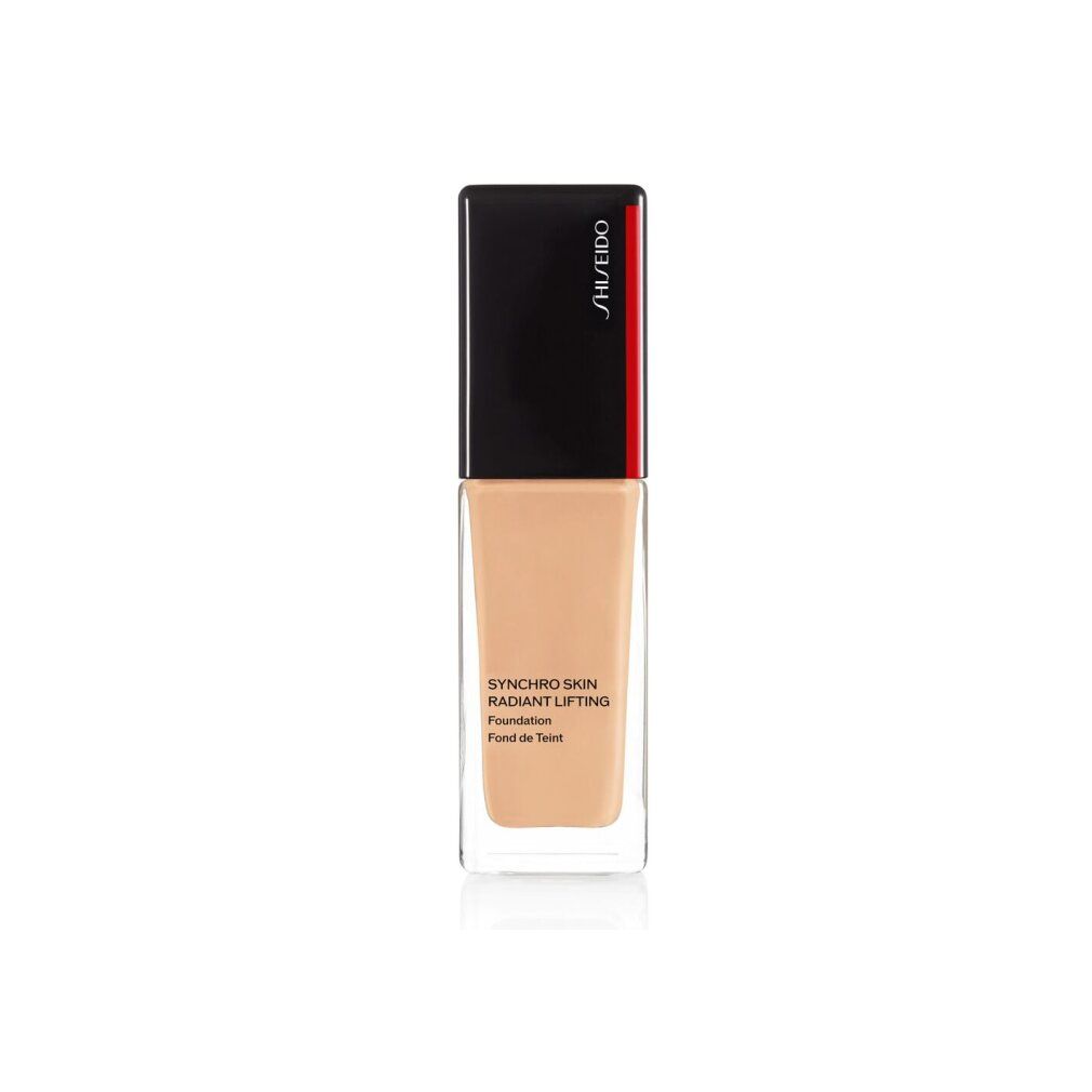 Shiseido Synchro Skin Radiant Lifting Foundation Flakon. Rechteckige Form, transparente Basis, schwarzer Deckel mit rotem Akzent. Text.