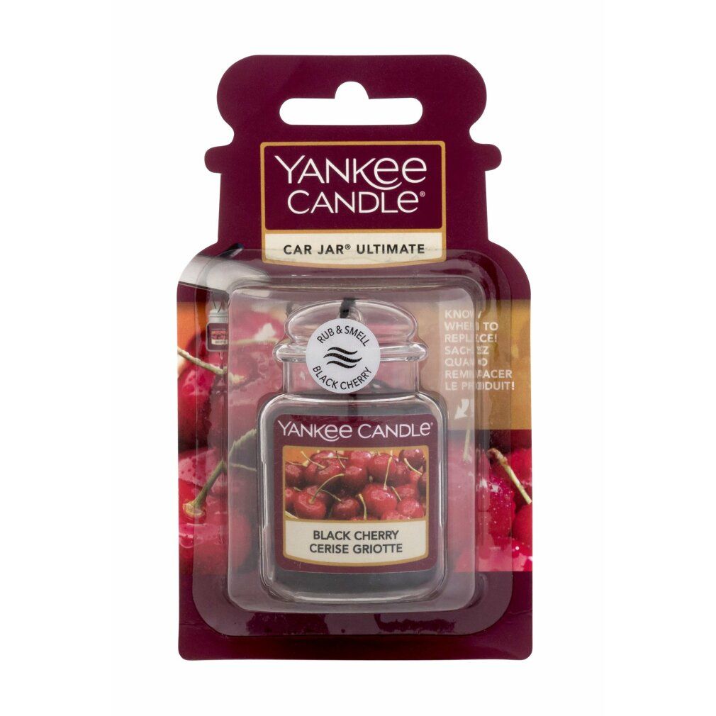 Yankee Candle Autoerfrischer. Schwarze Kirsche. In Verpackung. Klares Glasgefäß mit Metallverschluss. Kirschabbildung. "Rub & Smell" Text.