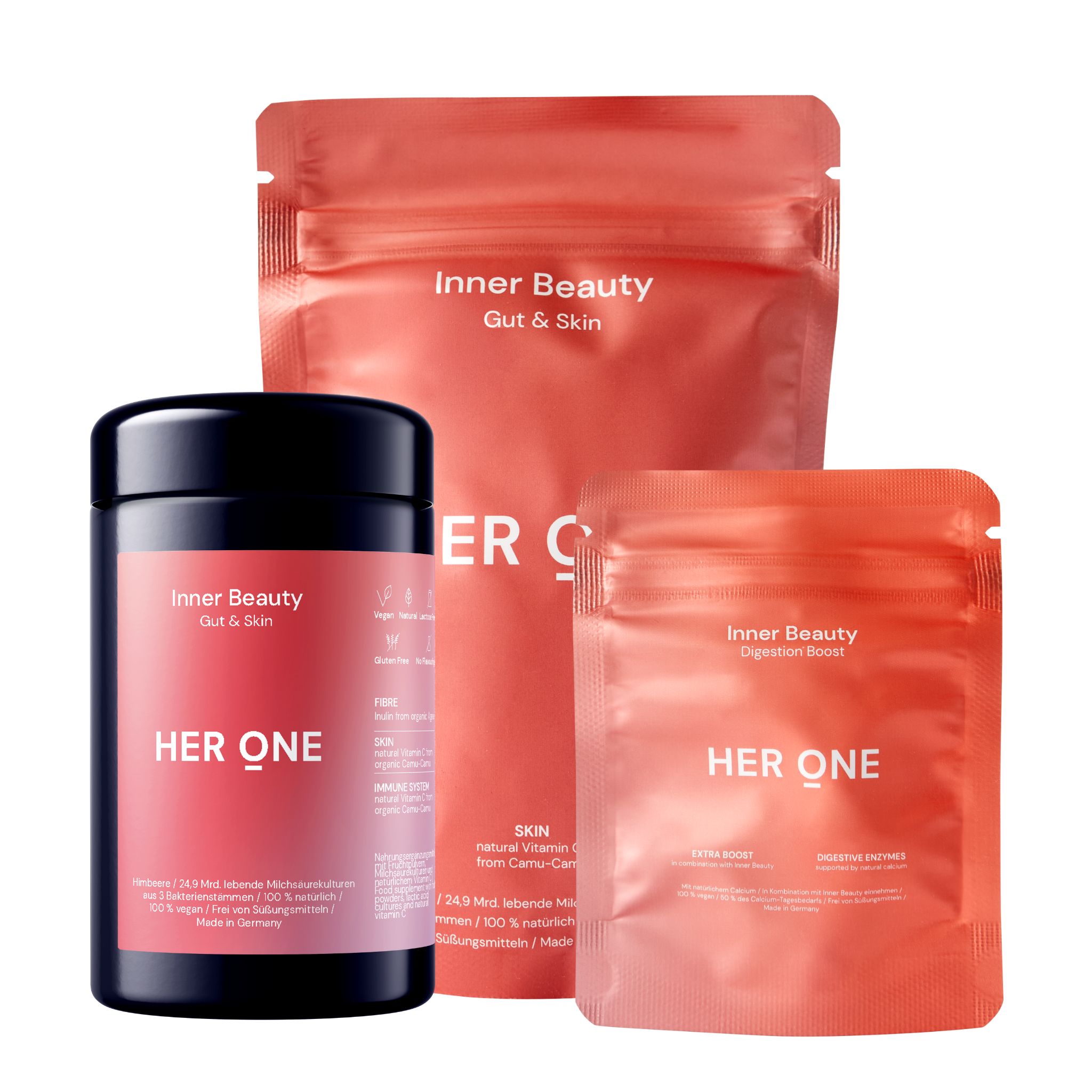 Drei HER ONE Produkte: Dose und zwei Beutel. Aufschrift: Inner Beauty Gut & Skin, HER ONE. Rote und schwarze Verpackung.