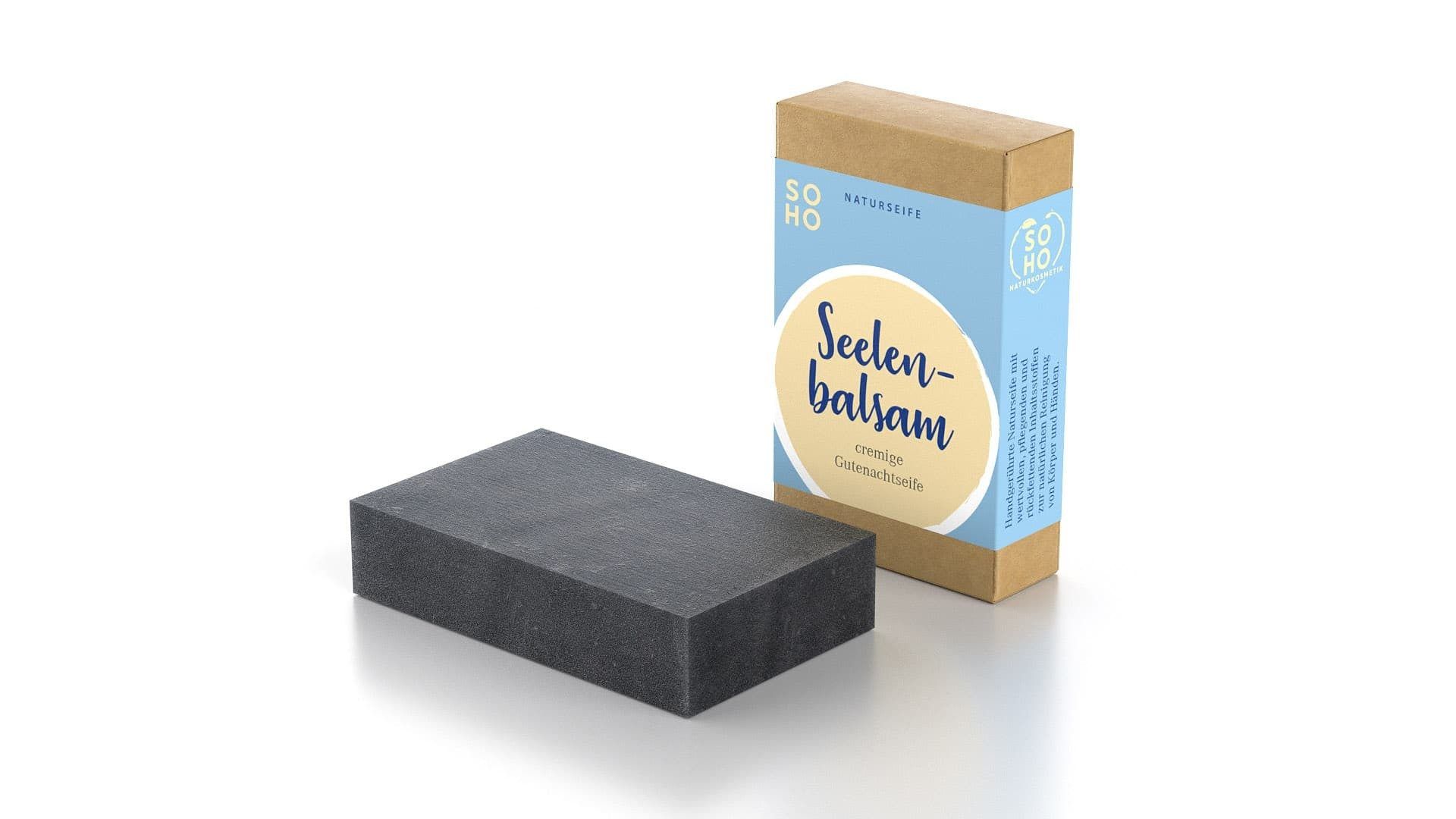Dunkle Körperseife neben Kartonverpackung. Aufschrift: Seelenbalsam. Marke: SOHO Naturkosmetik.