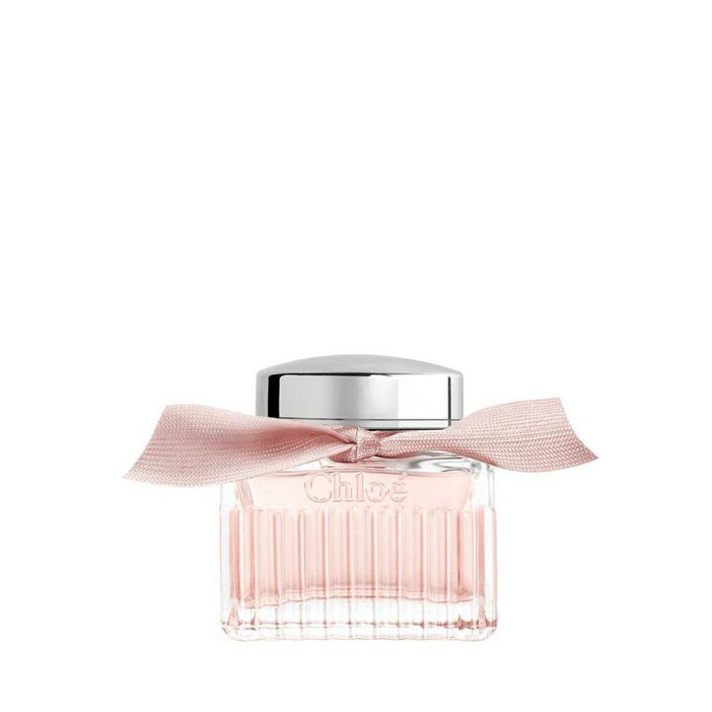 Quadratischer Glasflakon mit silbernem Deckel und rosa Schleife. Der Flakon enthält eine rosa Flüssigkeit.