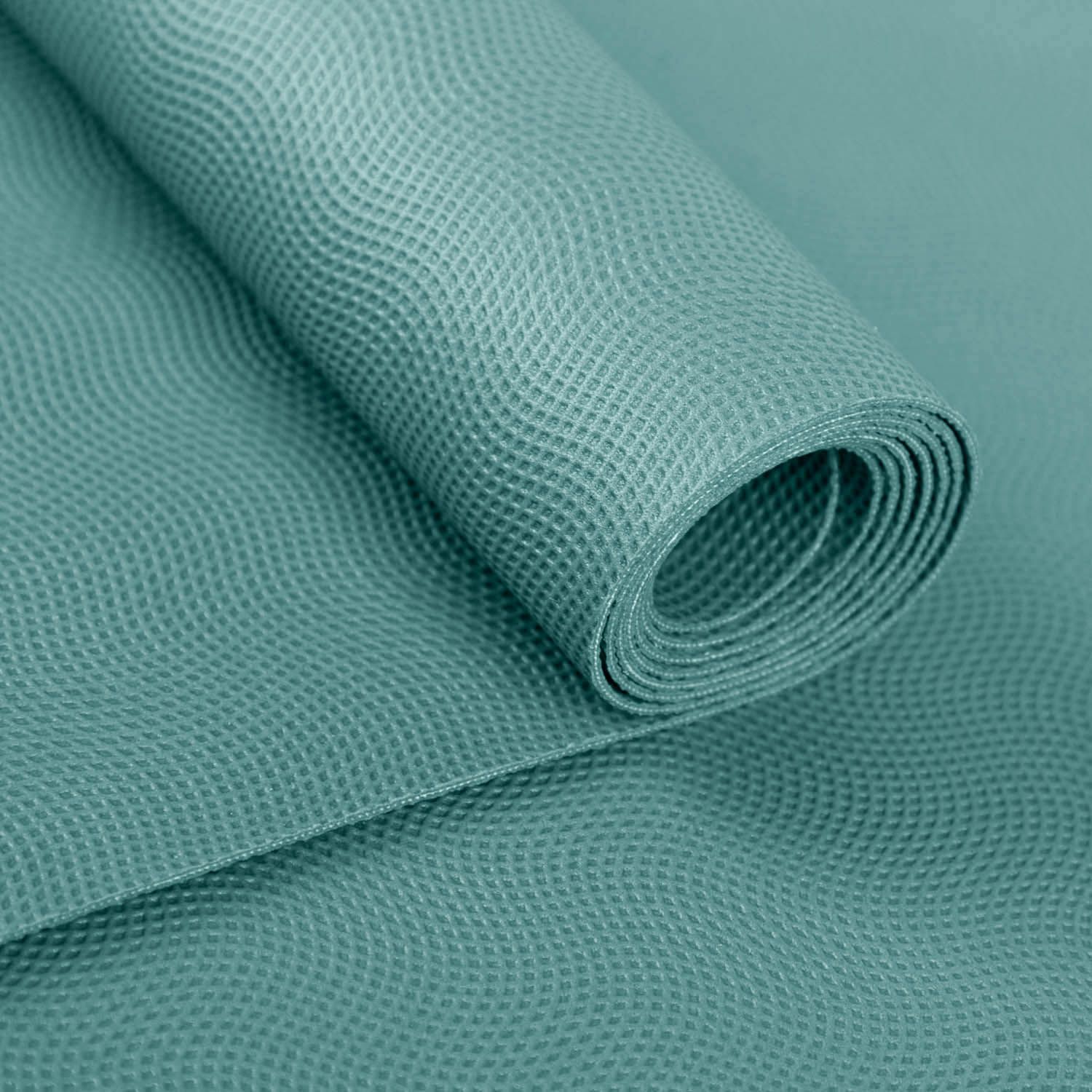 Gerolltes Ende einer türkisfarbenen Yogamatte. Strukturierte Oberfläche. Naturkautschuk.