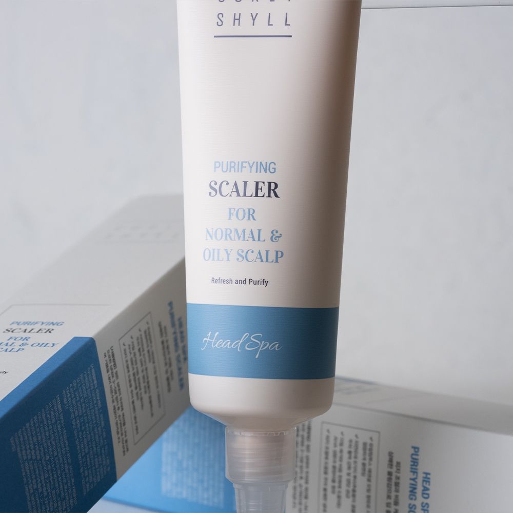Tube und Verpackung. Produktname und -beschreibung sichtbar. Blaue und weiße Farbgebung.