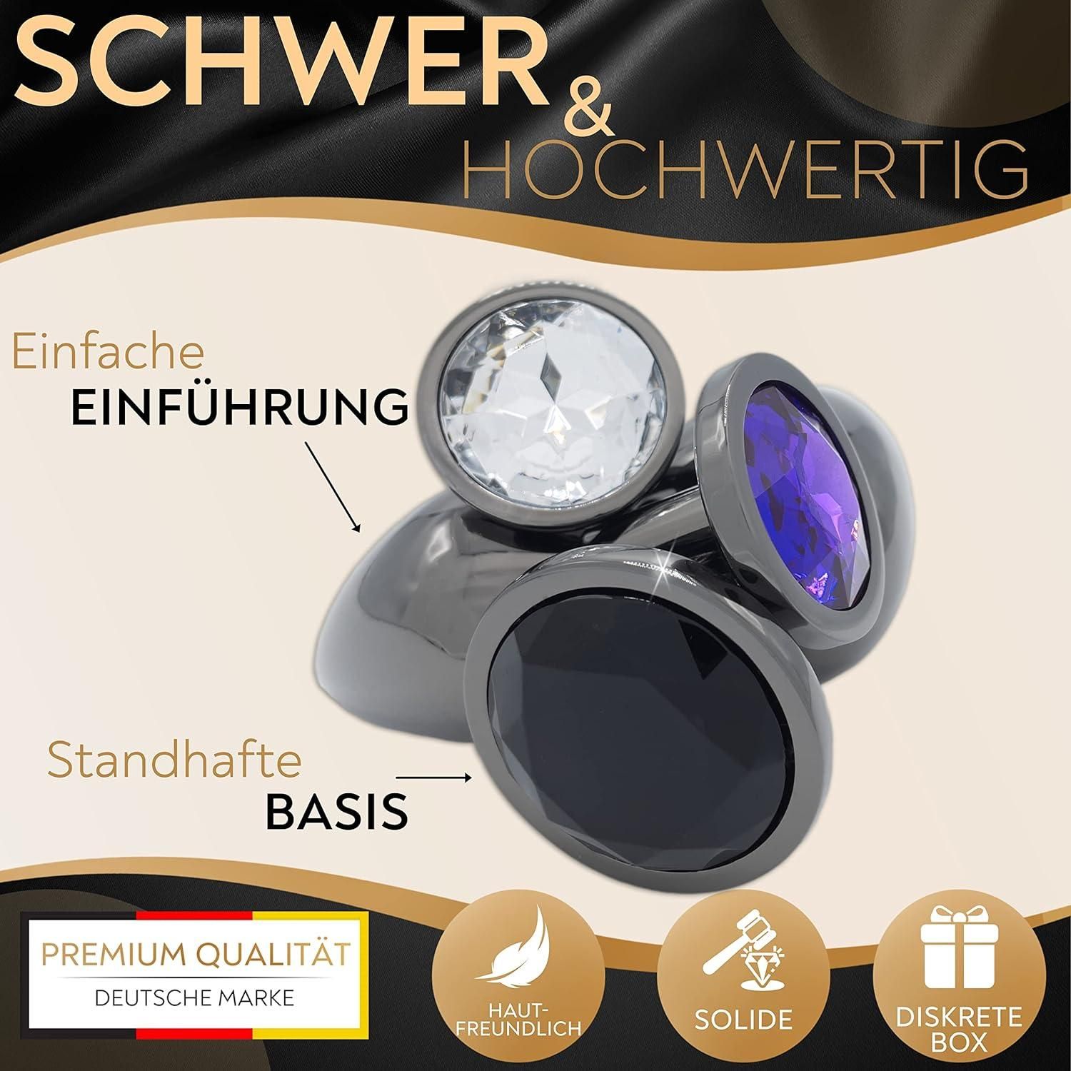 Drei Analplugs mit Edelstein-Optik. Schwarze, transparente und violette Steine. Schwarze Basis. Text: Einfache Einführung, Standfeste Basis, Hochwertig.
