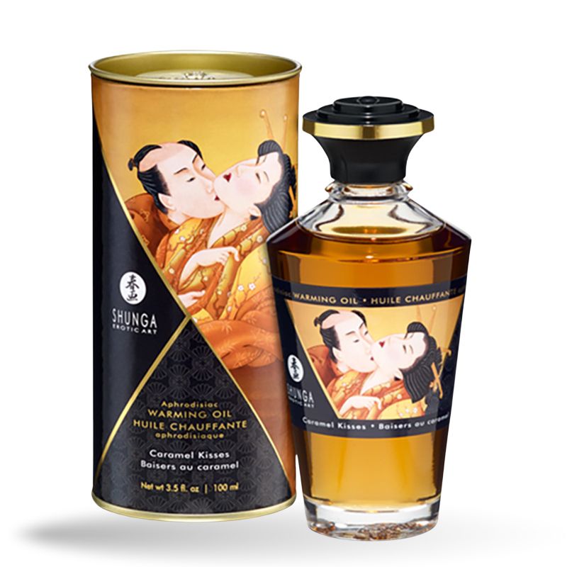 Glasflasche und Dose mit Etiketten. Aufschrift: Shunga, Warming Oil, Caramel Kisses. Abbildung: küssendes Paar.