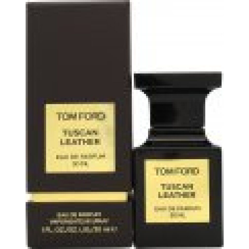 Schwarzer Flakon neben einer schwarzen Schachtel. Goldfarbenes Etikett mit Aufschrift: TOM FORD TUSCAN LEATHER. 50 ml.