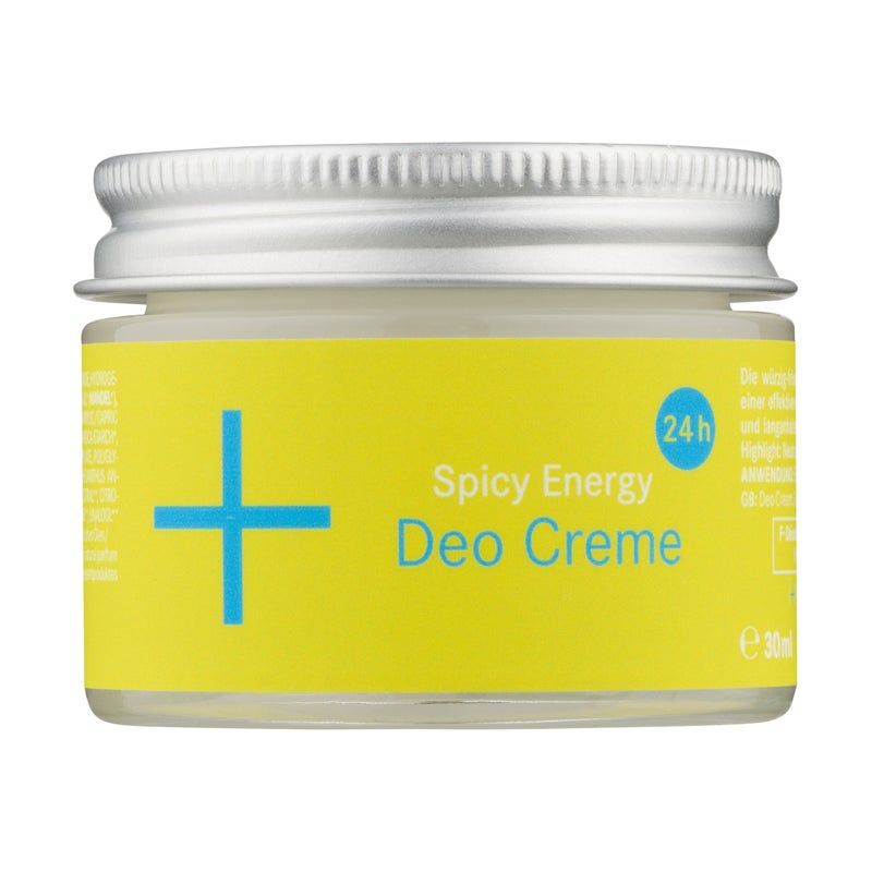 Glasbehälter mit silbernem Deckel. Gelbes Etikett mit blauem Kreuz und Text: Spicy Energy Deo Creme. 24h-Symbol.