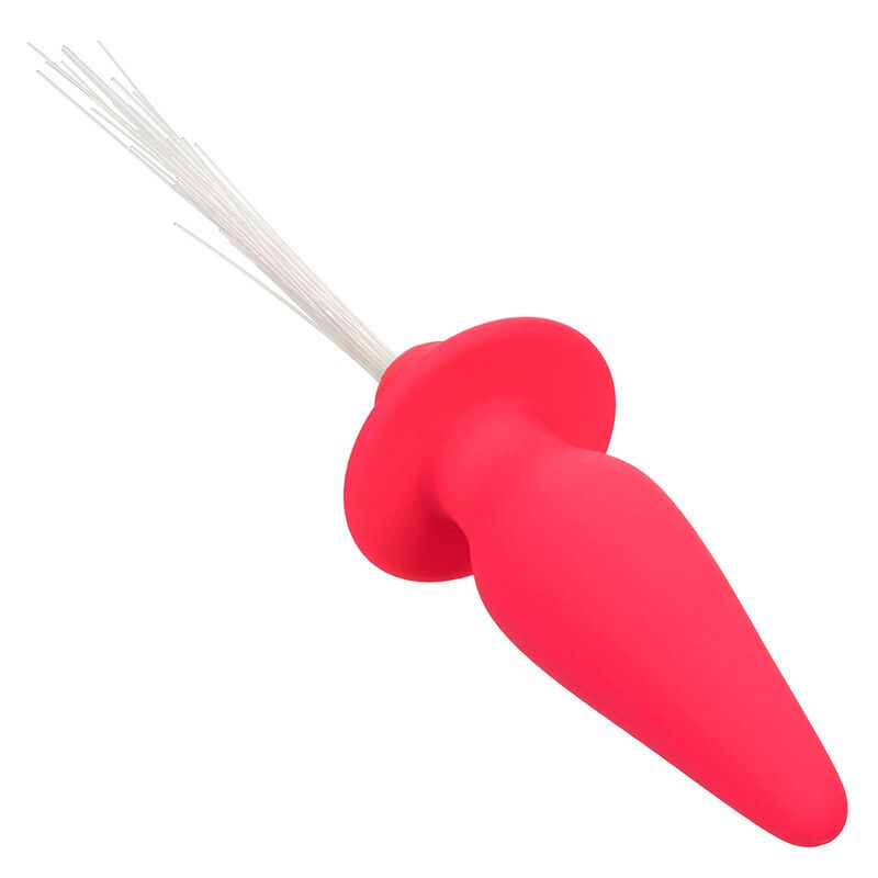 Pinkfarbener Analplug aus Silikon. Kegelförmiger Schaft, runder Flansch. Weiße Lichtfasern am Ende.