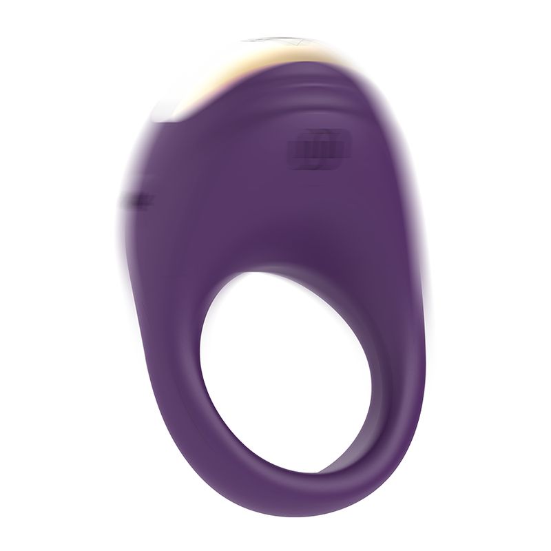 Vibrierender Ring, lila mit goldfarbenem Element. Ringförmiges Design mit abgerundeter Oberseite. Unschärfe-Effekt.