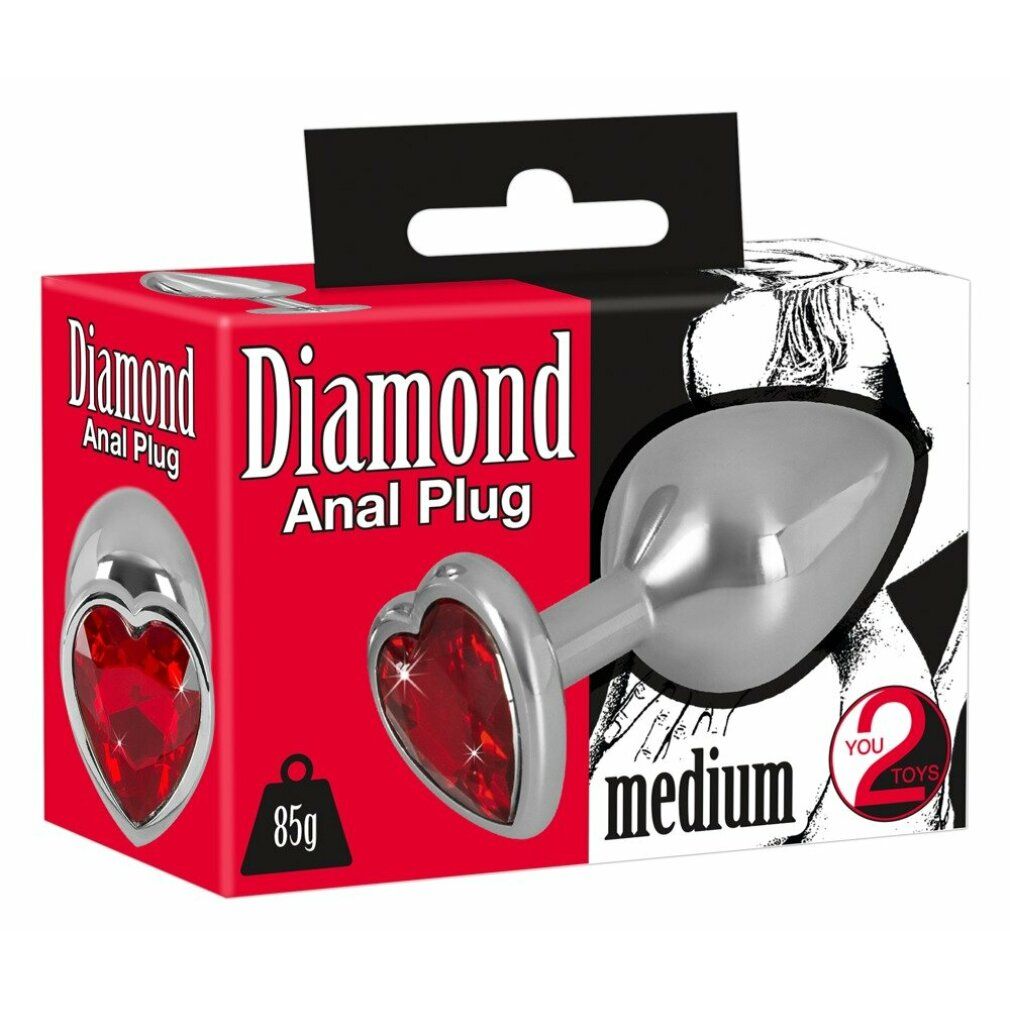 Verpackung mit Analplug. Aufschrift: Diamond Anal Plug medium. Herzförmiger, roter Schmuckstein.