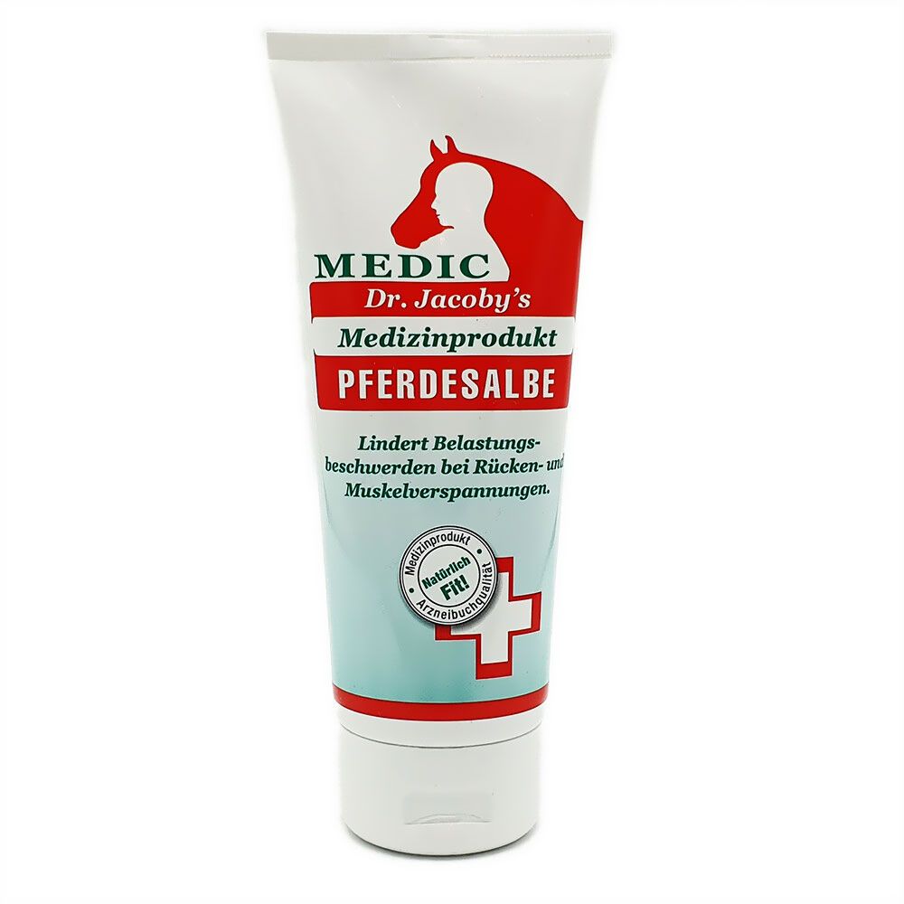 Weiß-rote Tube mit Produktnamen und Logo. Text: MEDIC, Dr. Jacoby's, Pferdesalbe. Abbildung eines Pferdekopfes. Zertifizierungslogo.