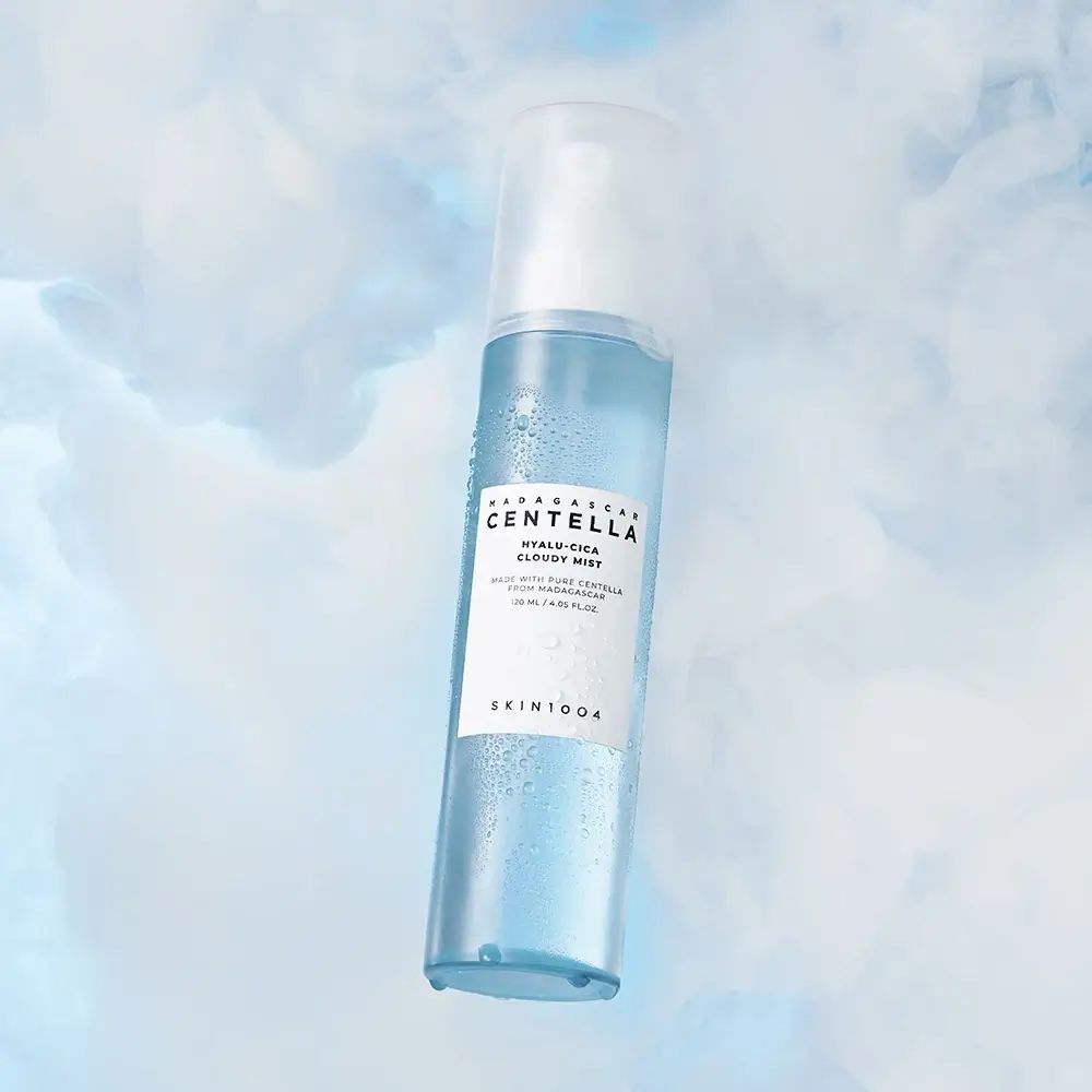 Blau-transparente Sprühflasche mit Nebel. Aufschrift: MADAGASCAR CENTELLA, HYALU-CICA Cloudy Mist. SKIN1004.