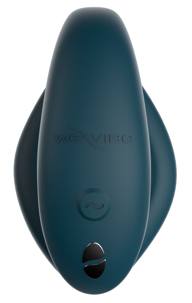 Petrolgrünes Wellness-Produkt mit abgerundeter Form. Glatte Oberfläche. Logo 'we vibe' und ein Knopf. Draufsicht.