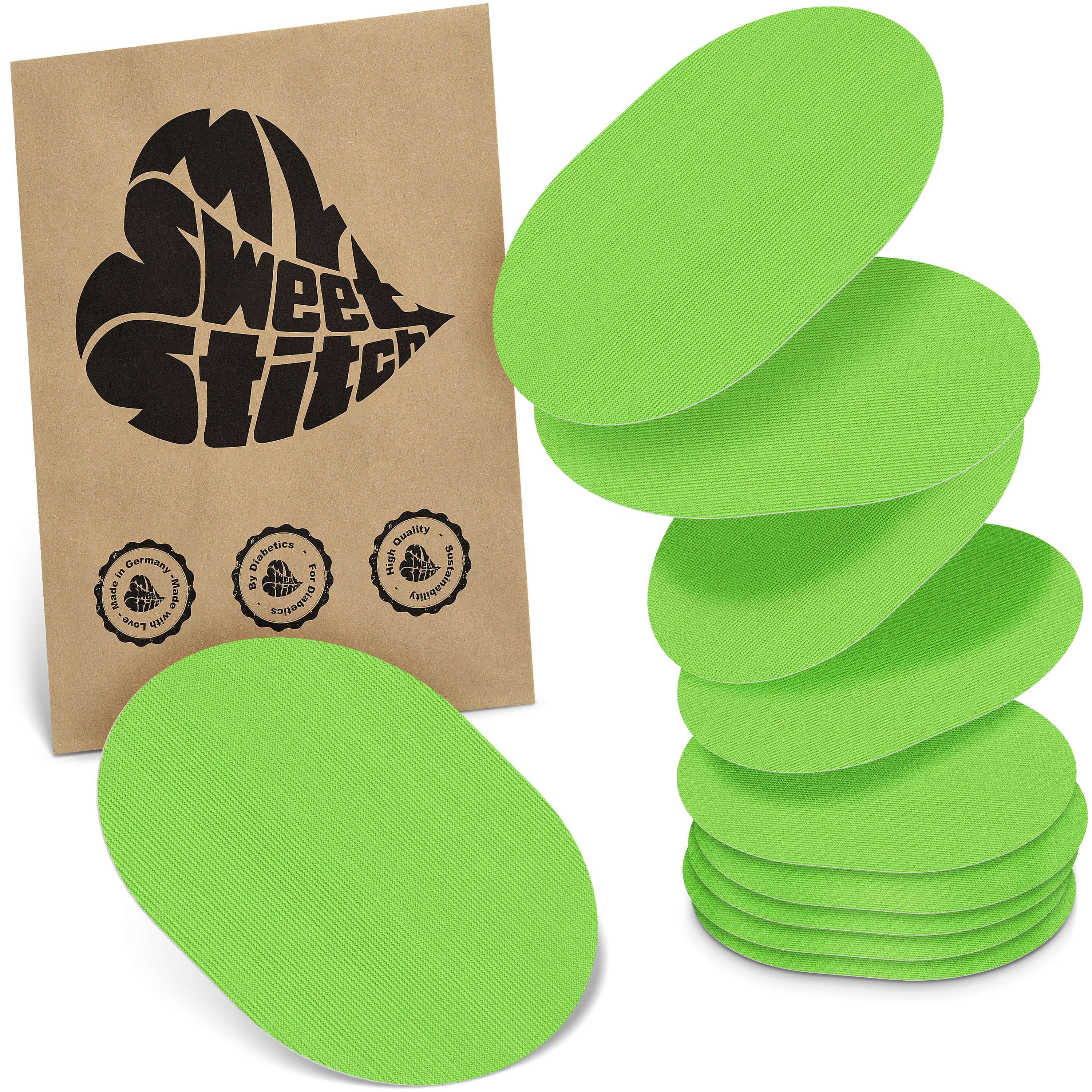 Grüne, ovale Pflaster. Auf brauner Verpackung steht "My Sweet Stitch". Verpackung mit Qualitätssiegeln. Mehrere Pflaster gestapelt.