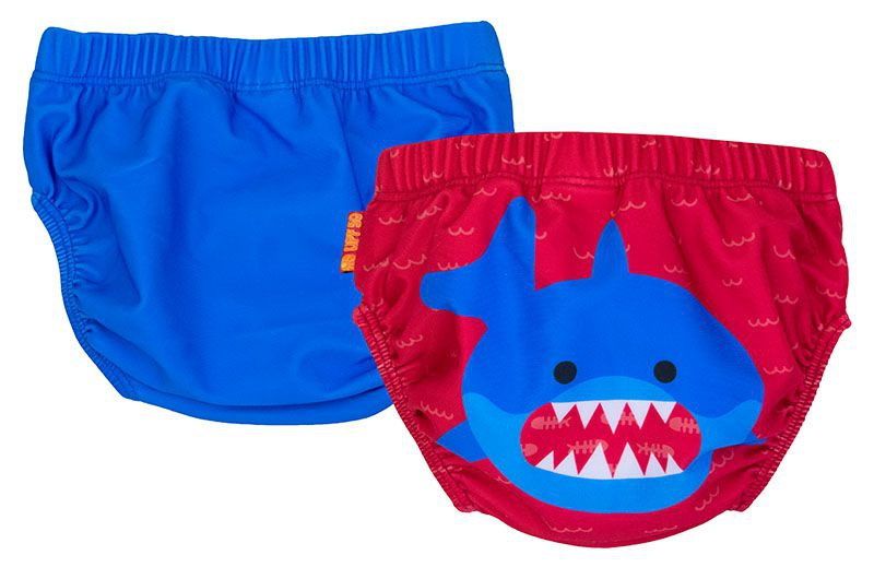 Zwei Baby-Badehosen. Eine blaue, eine rote mit Hai-Motiv. Elastischer Bund. Auf roter Hose: Hai-Gesicht mit Zähnen.