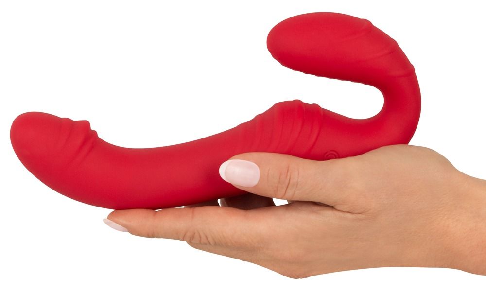 Roter Paarvibrator mit geschwungener Form und gerippter Oberfläche. Ein rotes Bedienelement mit "2" ist sichtbar.