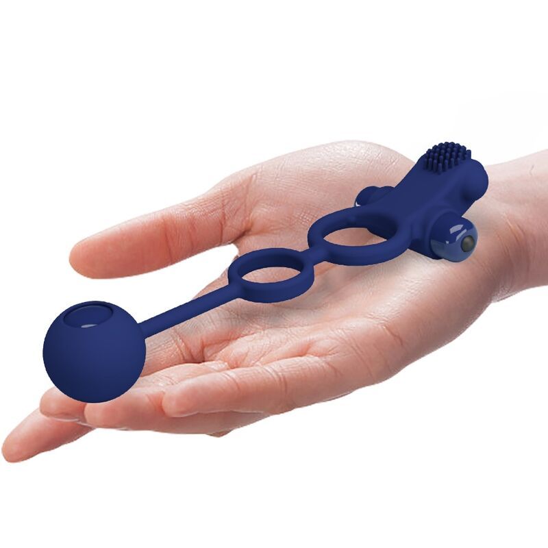 Blauer Vibrationsring, gehalten in einer Hand. Der Ring hat eine Kugel und erhabene Elemente. Das Produkt ist aus Silikon.