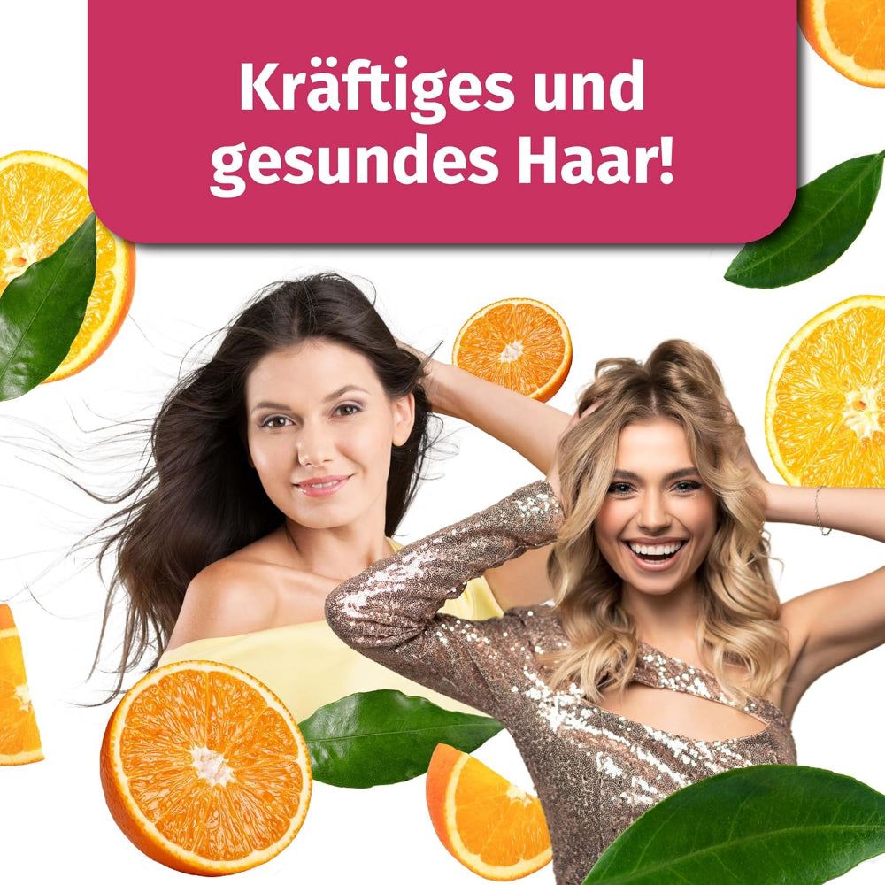 Zwei Frauen mit Orangen. Blond und brünett, lächelnd. Orangen und Blätter im Hintergrund.