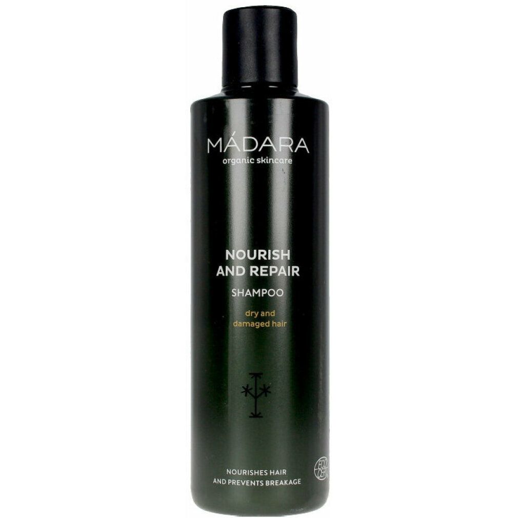 Dunkelgrüne Shampoo-Flasche mit schwarzem Deckel. Aufschrift: MÁDARA, Nourish and Repair Shampoo, für trockenes und strapaziertes Haar.