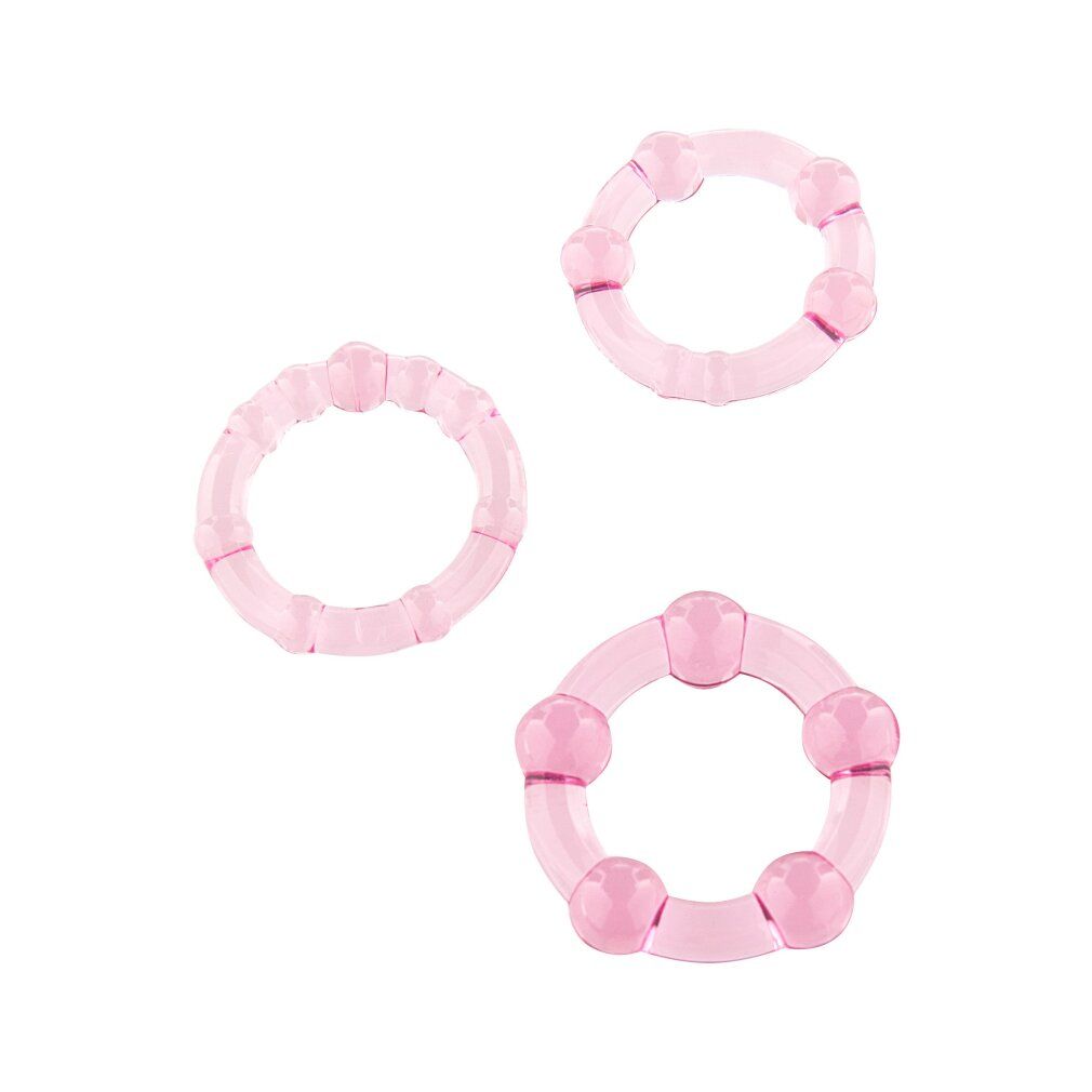 Drei rosa Penisringe. Unterschiedliche Größen und Formen. Aus transparentem Material mit abgerundeten Elementen.