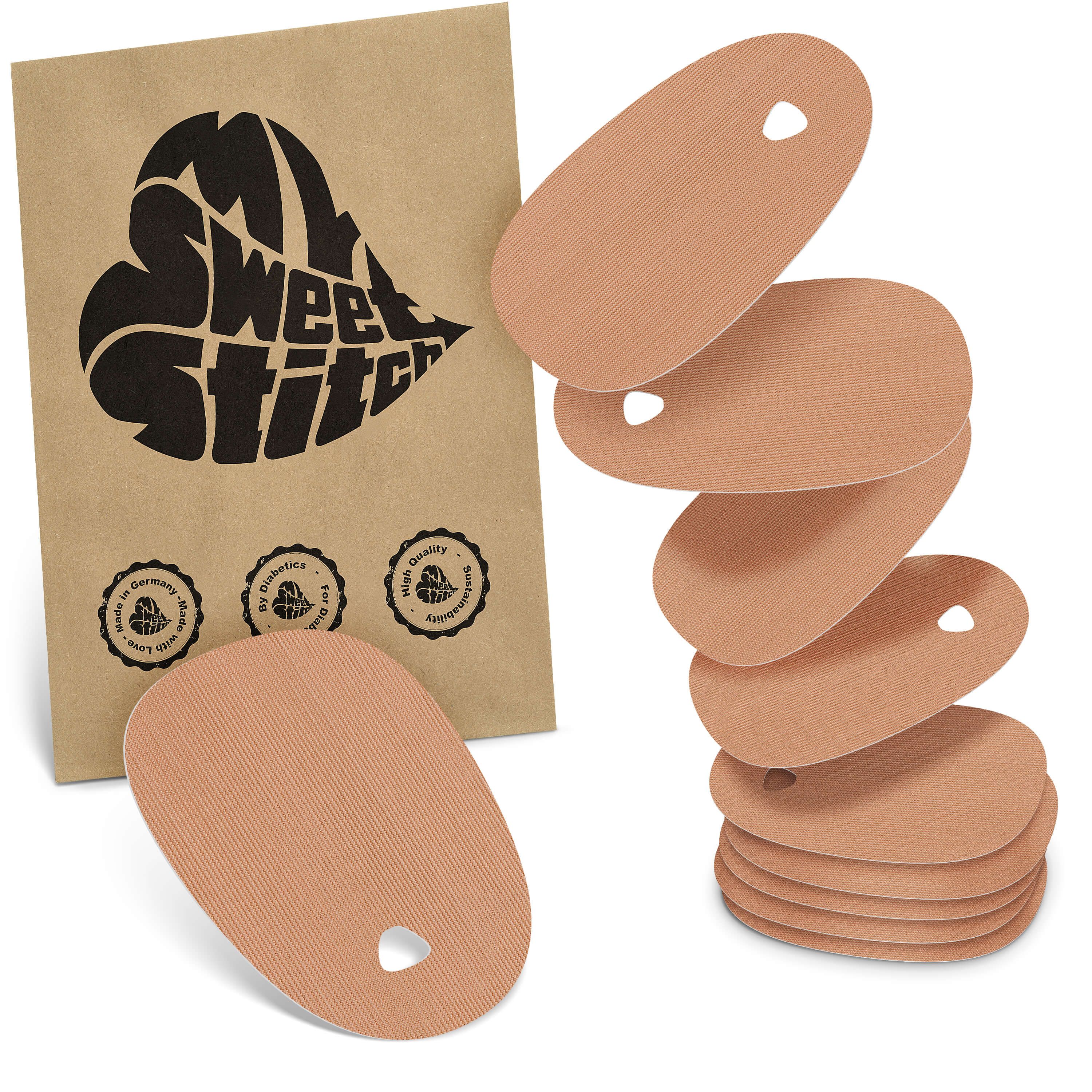 Mehrere ovale Pflaster mit Aussparung, in einer braunen Verpackung. Aufgedrucktes Logo: MySweetStitch.