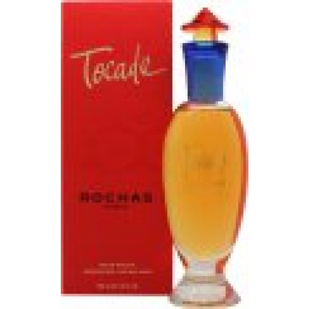 Rote Verpackung und Glasflakon. Goldener Schriftzug "Tocade" auf der Verpackung. Flakon mit gelber Flüssigkeit, blauem Hals und rotem Verschluss.