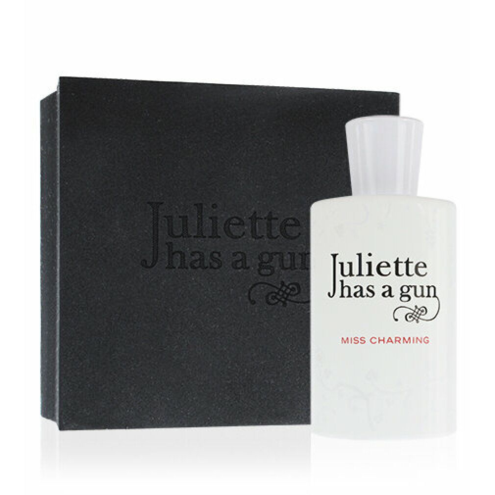 Weißes Parfümflakon mit schwarzer Schachtel. Aufschrift: Juliette has a gun, Miss Charming.
