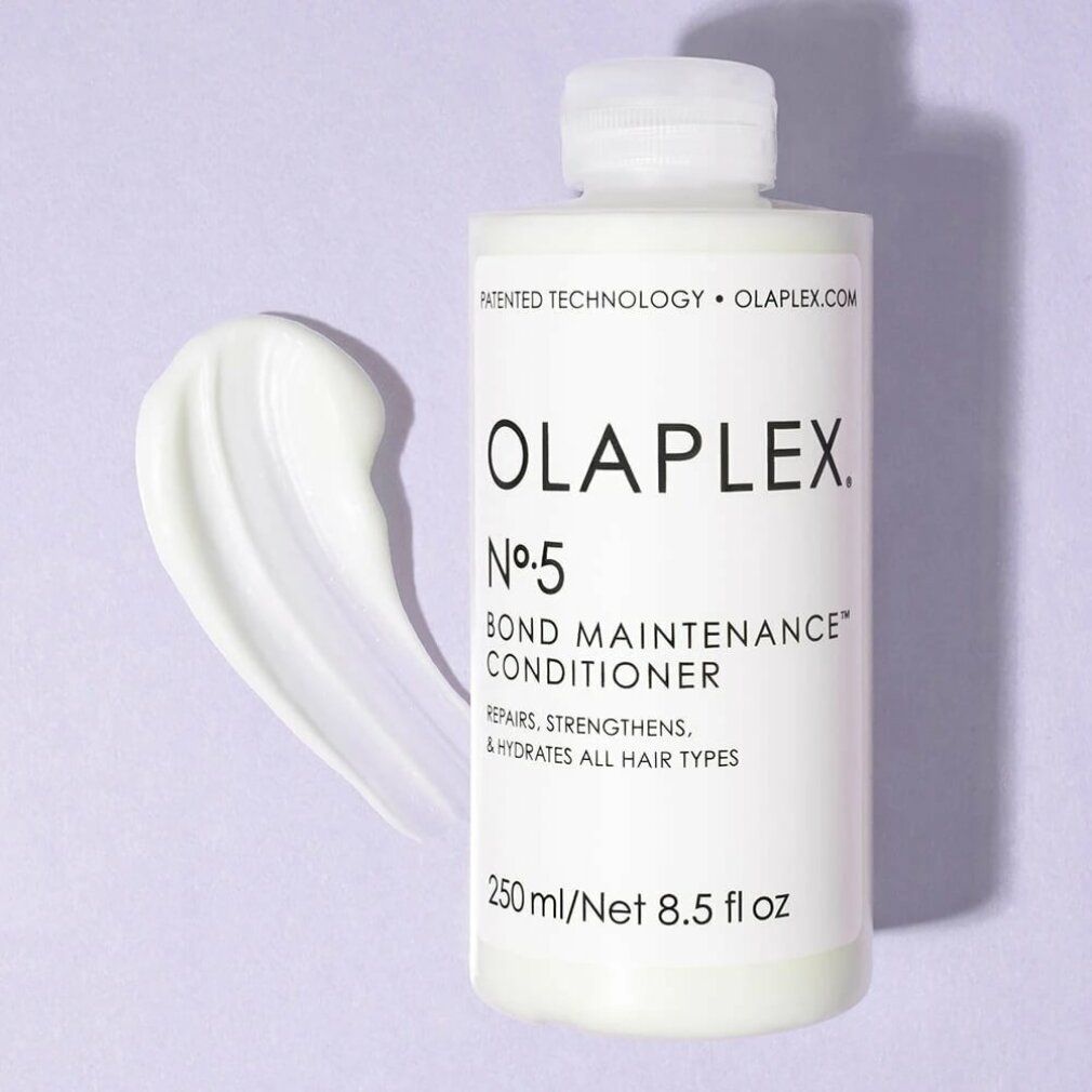 Weiße Flasche Olaplex Nº5 Bond Maintenance Conditioner mit cremiger Substanz daneben. Enthält 250 ml/8,5 fl oz. Repariert, stärkt und hydratisiert.