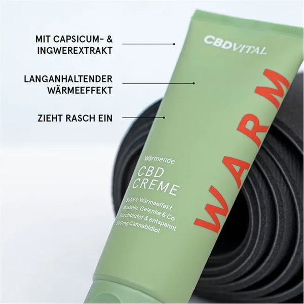 Grüne Tube mit roter Schrift. "Wärmende CBD Creme". Text: Mit Capsicum- & Ingwerextrakt, langanhaltender Wärmeeffekt.
