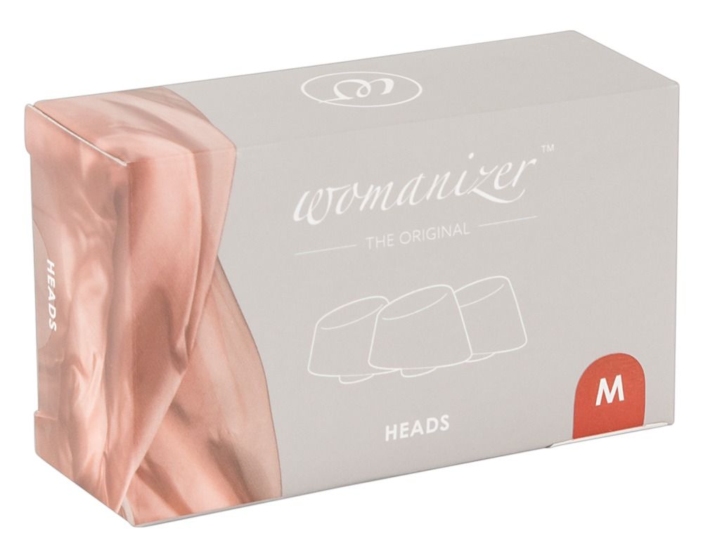 Verpackung mit Ersatzkappen. Aufdruck: Womanizer, Heads, M. Abbildung von drei Köpfen.