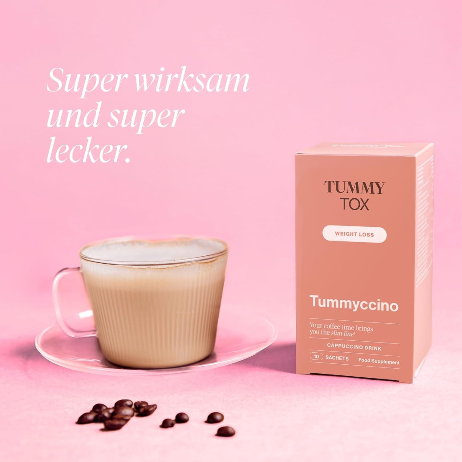 Tummy Tox Tummyccino-Packung neben Cappuccino in Glasbecher. Aufschrift: 10 Sachets, Cappuccino Drink.