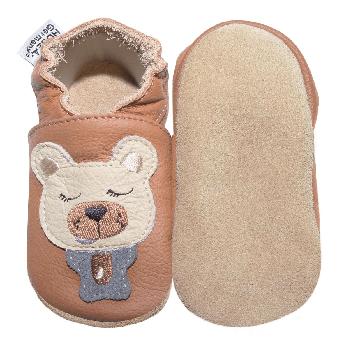 Braune Babyschuhe mit Bärenmotiv. Ein Schuh von unten, Sohle aus hellem Leder. Marke HOBEA-Germany.
