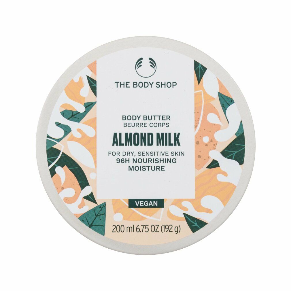 Runde Dose mit Deckel. Aufschrift: The Body Shop, Body Butter Almond Milk. Für trockene, empfindliche Haut. Vegan. 200 ml.