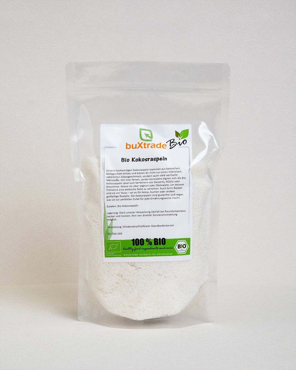 Transparente Verpackung mit buXtrade Bio Kokosraspeln. Text und Bio-Siegel. Produktansicht.