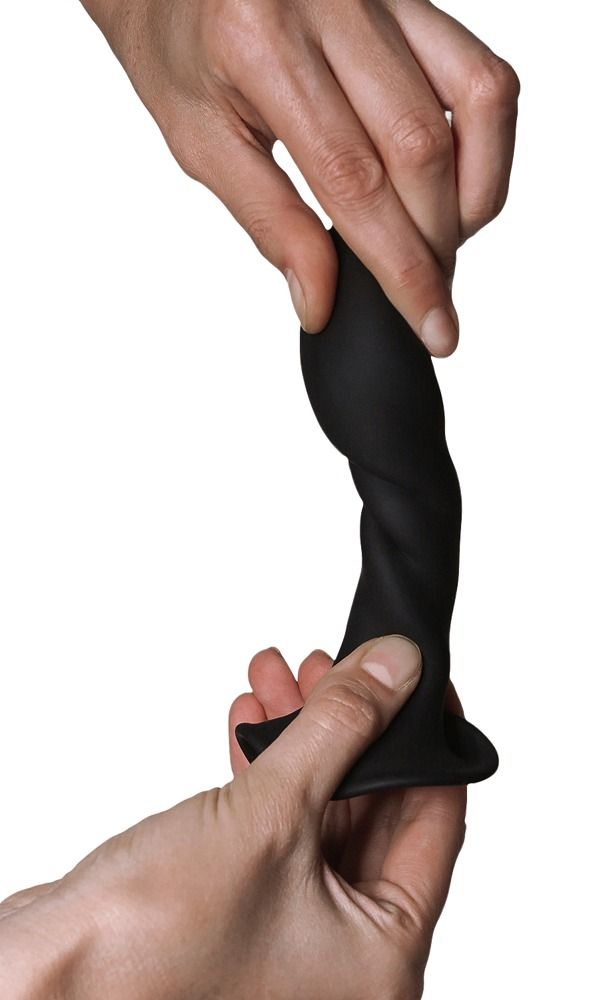 Schwarzer Dildo, gewunden, in Händen gehalten. Breiter Fuß, geschwungene Form.