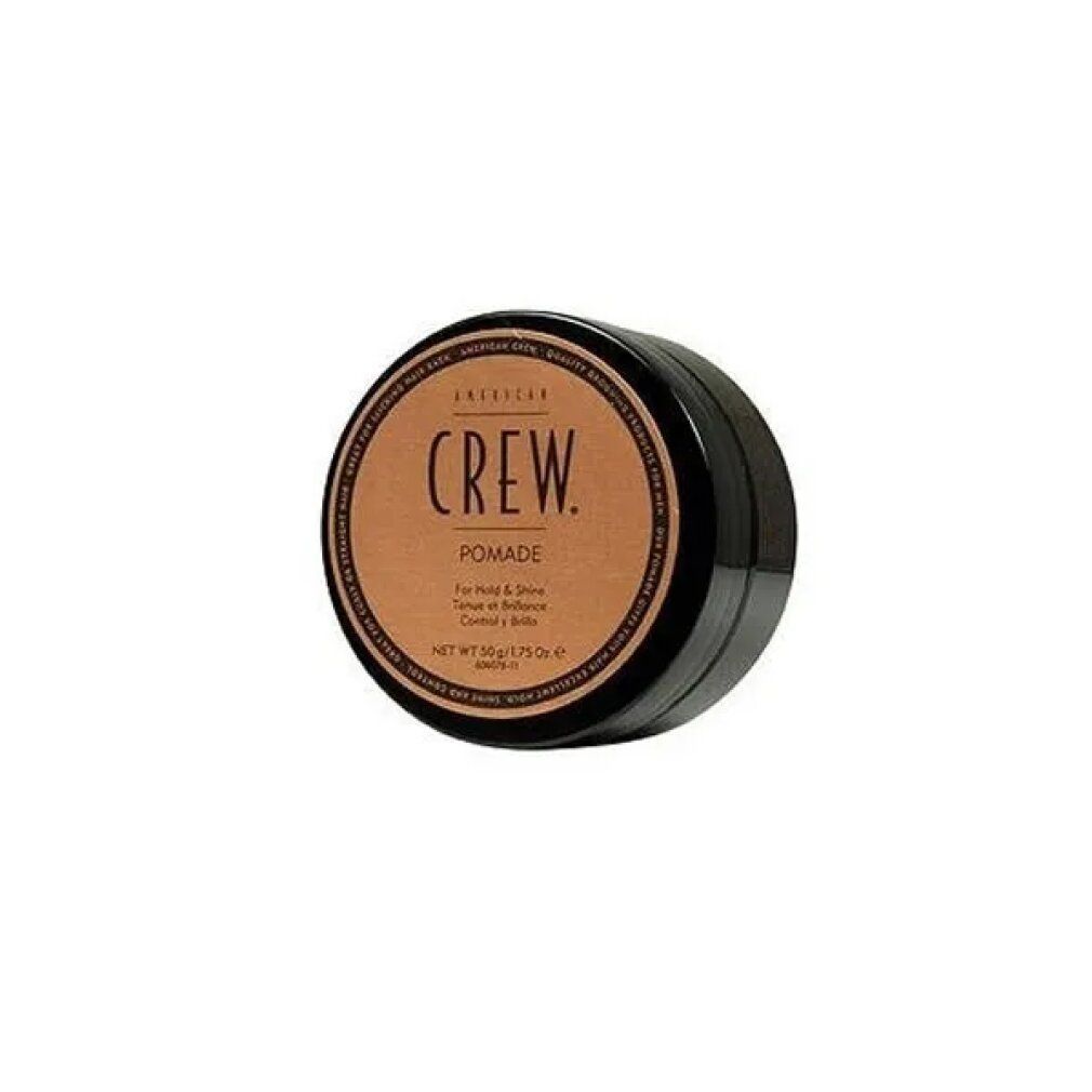 Runde, schwarze Dose mit braunem Deckel. Aufschrift: CREW. Pomade. Für Halt & Glanz. Netto 50g/1.75 Oz.