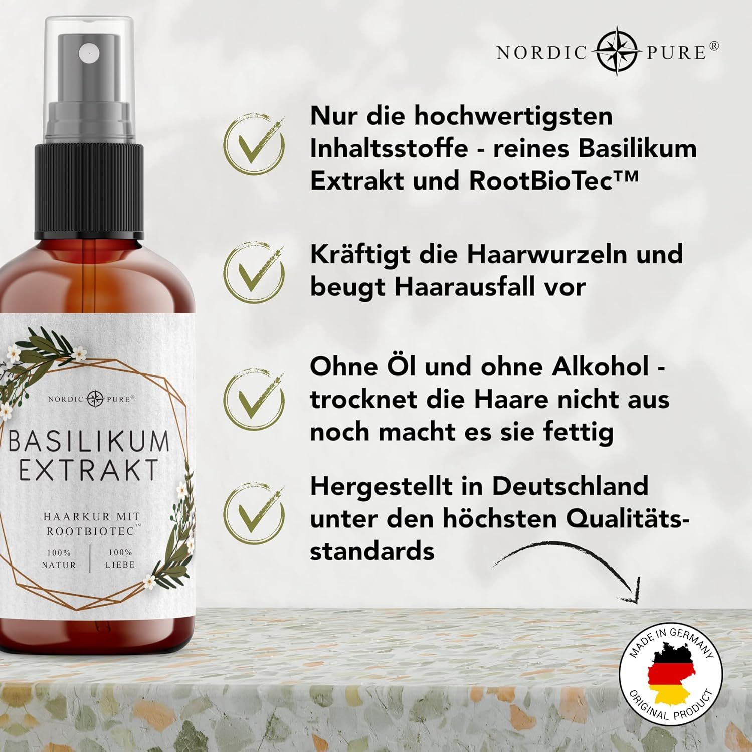 Flasche mit Sprühkopf. Text: Basilikum Extrakt, Haarkur mit Rootbiotec. Logo: Nordic Pure. Text: Hergestellt in Deutschland.