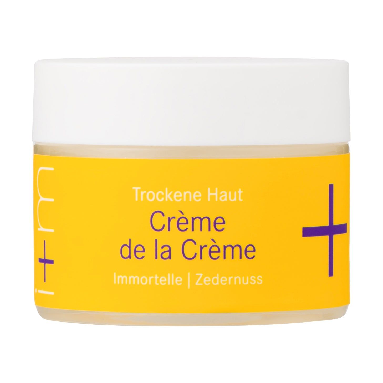 Creme-Tiegel mit gelbem Etikett. Aufschrift: Crème de la Crème, Trockene Haut. Marke: i+m Naturkosmetik. Weißer Deckel.