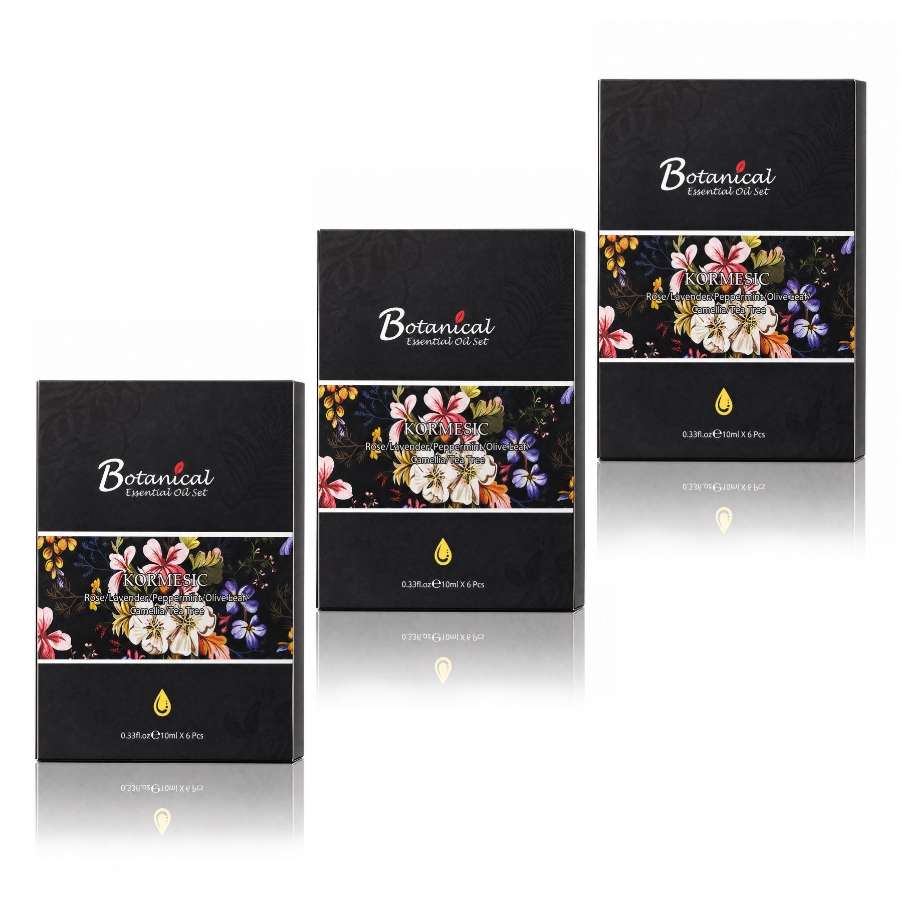 Drei schwarze Kartons für ätherische Öle mit floralem Muster und dem Schriftzug 'Botanical Essential Oil Set'.